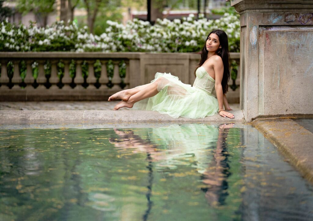 High School senior photo by the fountain at Rittenhouse Square wearing pretty gown