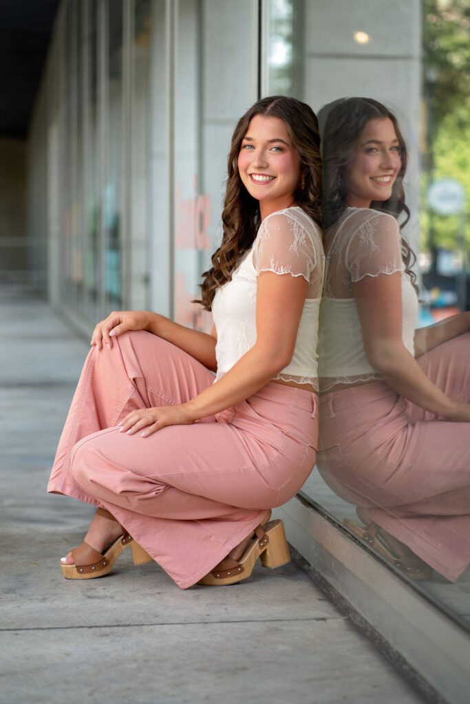 Senior wearing lace and pink posing downtown in New Jersey by photographer Susan Grace