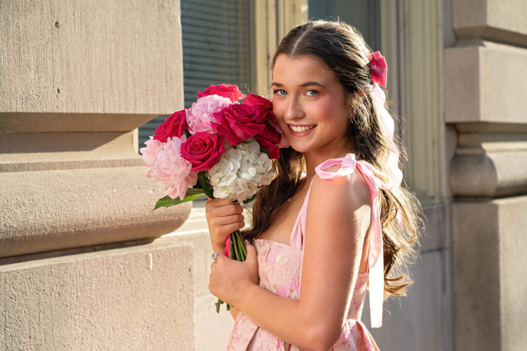 Senior wearing lace and pink posing downtown in New Jersey by photographer Susan Grace