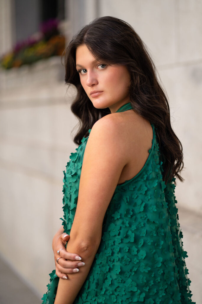 Aubrey's photo in the city in a green dress. Senior photography by Susan Grace Photography