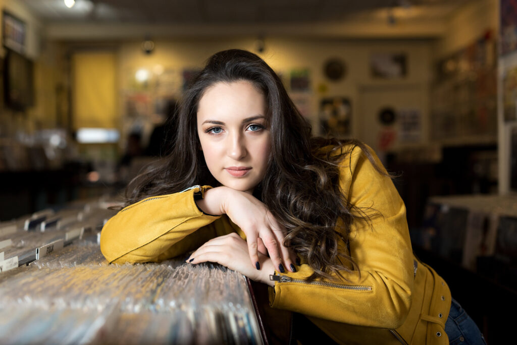 Modern senior image in record shop by NJ photographer Susan Grace